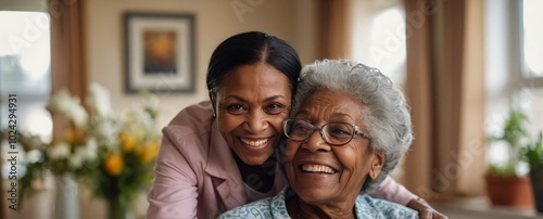 Happy senior black woman in a nursing home. Smiling old african american female pensioner being cared for by a nurse