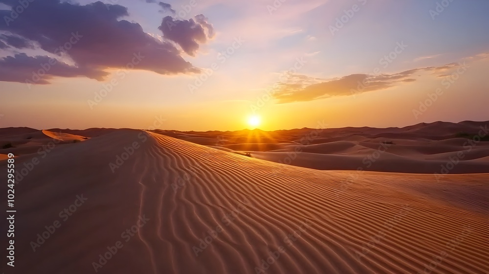 Breathtaking Sunset Landscape Featuring Dramatic Desert Dunes and Vibrant Orange and Purple Sky Creating a Serene and Captivating Atmosphere