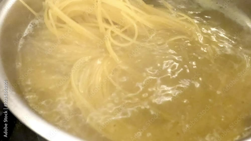 Freshly made pasta cooking in a pot of boiling water, beautifully showcasing the rich art of Italian cuisine Freshly made pasta cooking in a pot of boiling water, beautifully showcasing the rich art of Italian cuisine