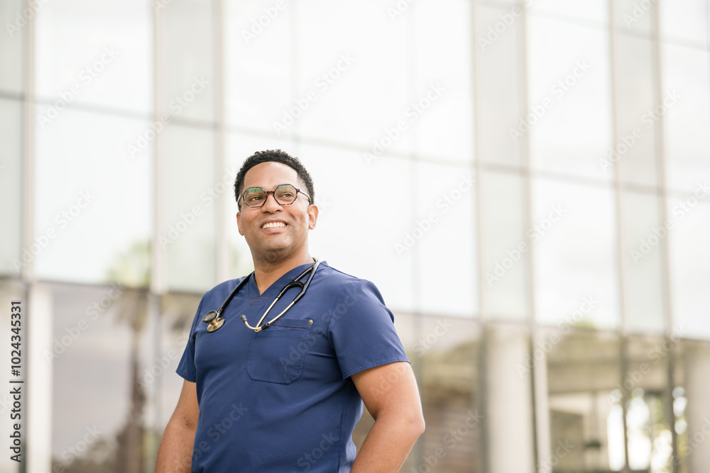 Male nurse in front of glass buillding smiling Male nurse in front of glass buillding smiling