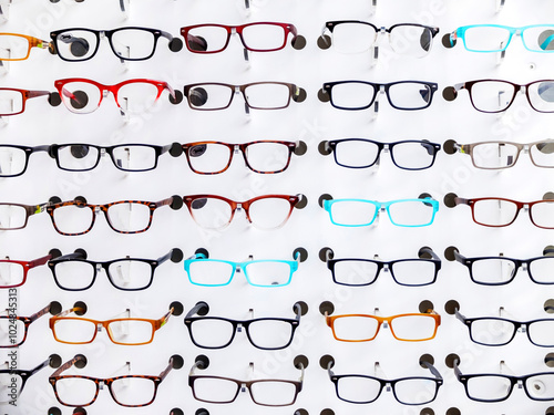 Exhibition of glasses in wall rack at optical shop