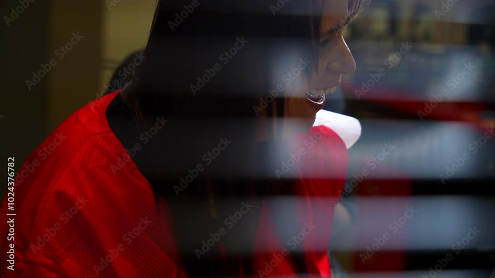 Panning left shot reveals a young woman laughing during a tattoo session Panning left shot reveals a young woman laughing during a tattoo session