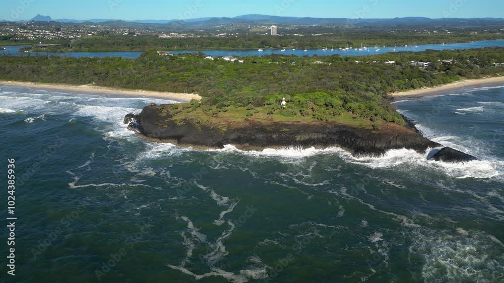 Right to left rotating aerial looking at Fingal Head Lighthouse from over the ocean on a sunny day, Northern New South Wales, Australia. Right to left rotating aerial looking at Fingal Head Lighthouse from over the ocean on a sunny day, Northern New South Wales, Australia.