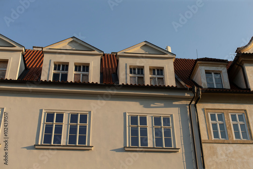 This is a charming building characterized by its red tiled roof and numerous windows that allow ample light to enter and enhance its design