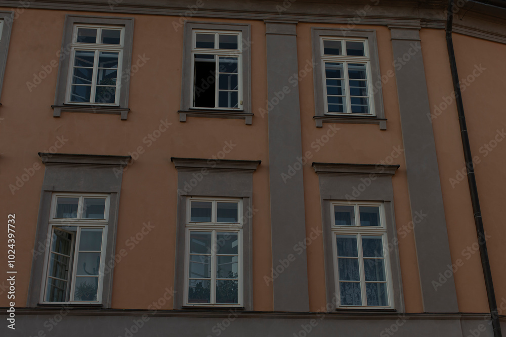A large structure featuring an abundance of windows adorning its exterior, creating an interesting and visually appealing facade A large structure featuring an abundance of windows adorning its exterior, creating an interesting and visually appealing facade