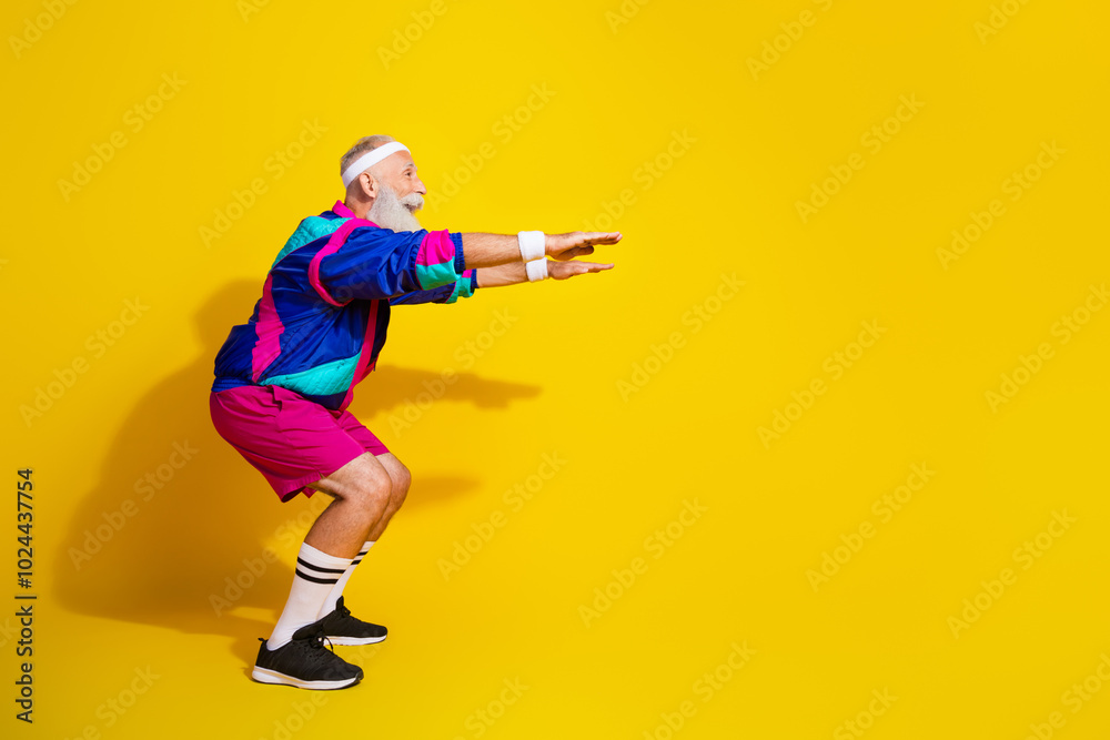 Full length photo of attractive funny retired sportsman retro sportswear squatting emtpy space isolated yellow color background Full length photo of attractive funny retired sportsman retro sportswear squatting emtpy space isolated yellow color background