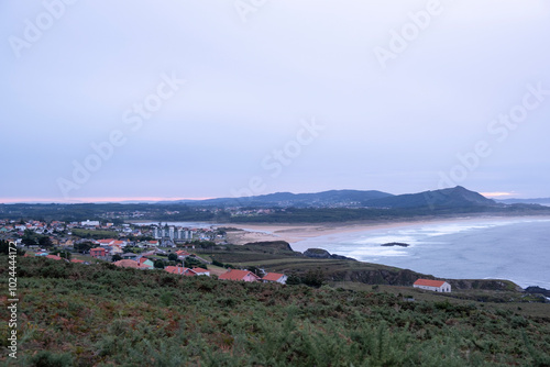 Panoramic view at nightfall of the town of Valdoviño and A Frouxeira beach photo