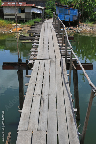 Wallpaper Mural Old wooden bridge across the canal in Thailand. Torontodigital.ca