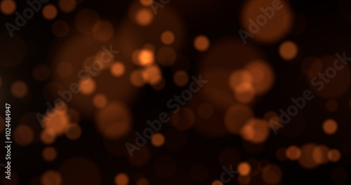 Abstract background with golden particles, golden light with particles shining bokeh on dark background, christmas concept.