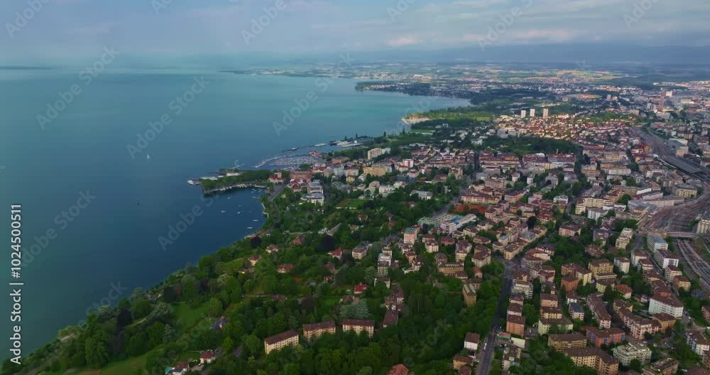 Lausanne is a modern city in the French-speaking Swiss canton of Vaud on the shores of Lake Geneva. A drone flies through city center of Switzerland from above aerial view by drone