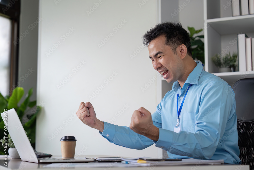 Fototapeta premium Triumphant Businessman Celebrating Success in Modern Office Concept of Career Achievement and Motivation