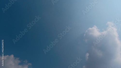 Timelapse of Blue Sky with Moving White Clouds in 4K photo