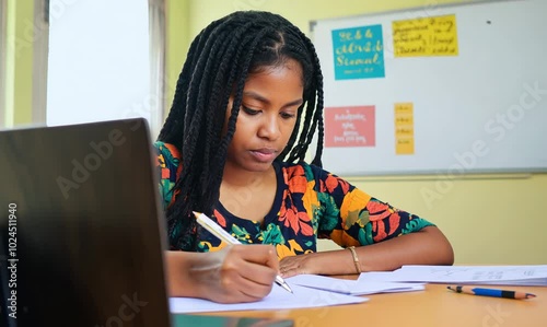 Ghanaian Woman Concentrating in Classroom During Test
