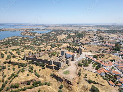 Aerial view of village and castle Mourao, district Evora,  Portugal, with Alqueva Dam behind photo