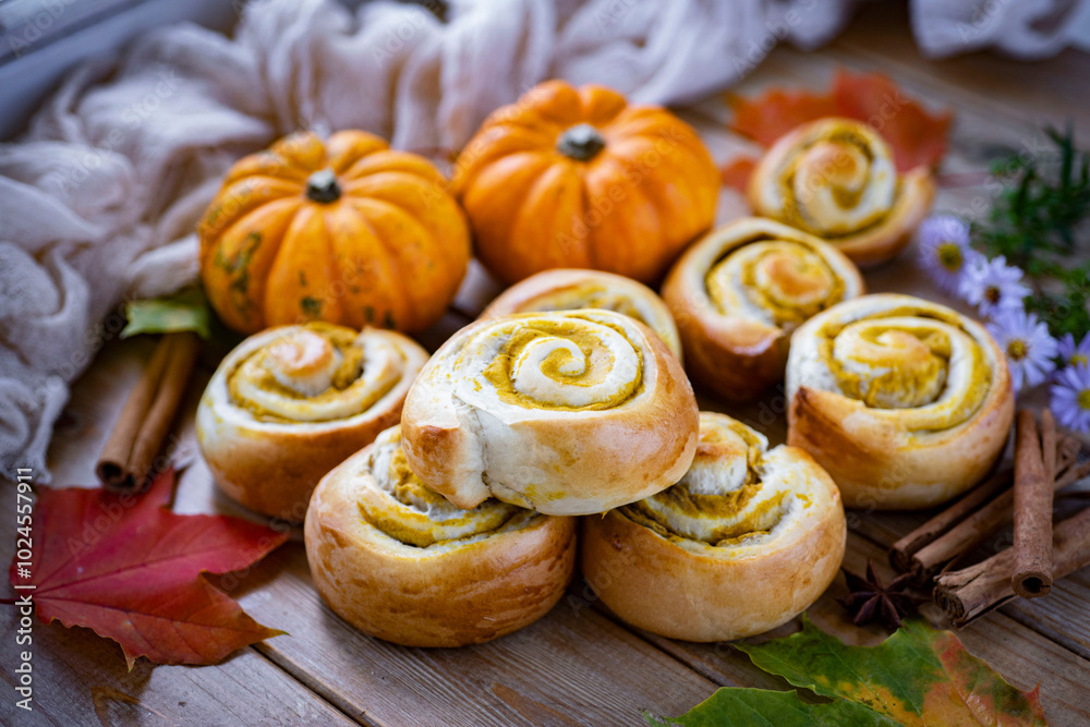 Autumn buns. Sweet buns with pumpkin. Buns with pumpkin filling on a wooden table. Close-up Autumn buns. Sweet buns with pumpkin. Buns with pumpkin filling on a wooden table. Close-up