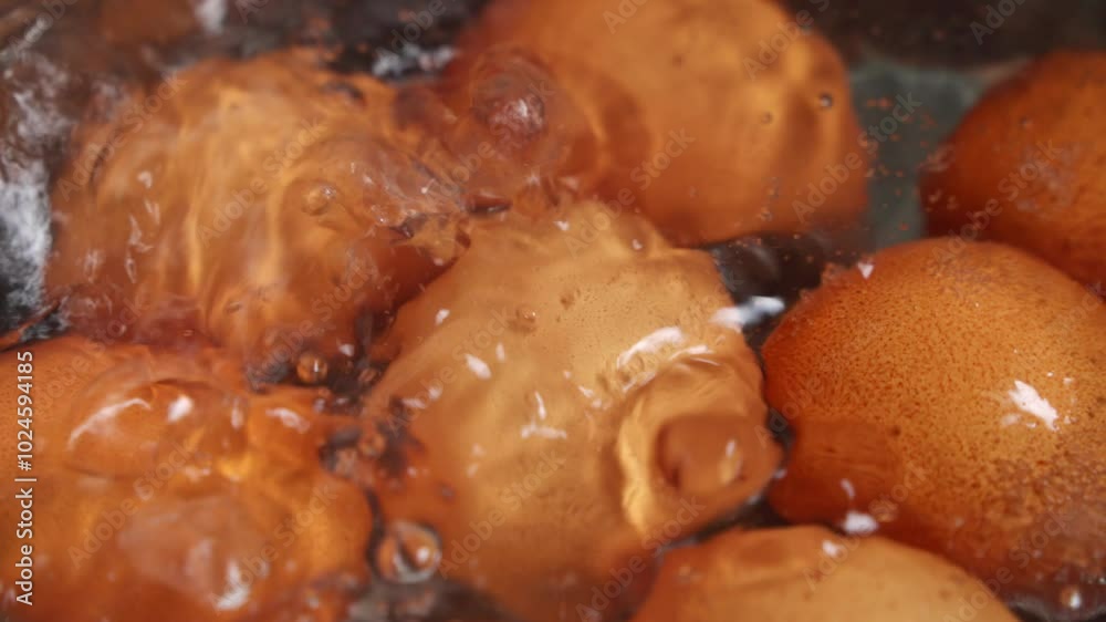 Eggs boiling in water, slow motion