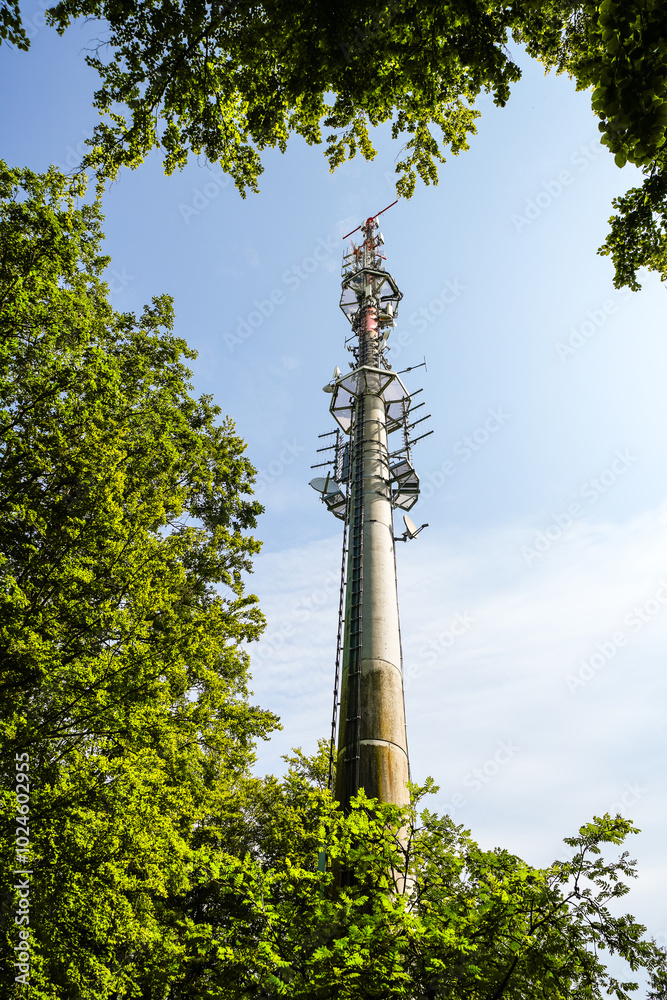 Obraz premium Transmission tower in the countryside. Radio tower in nature. 