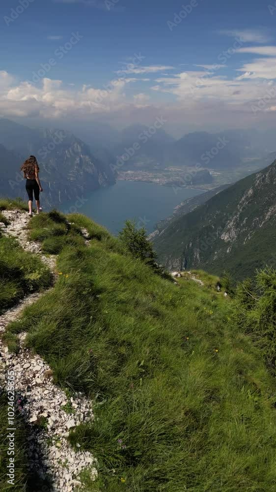 Video of young woman enjoying hiking in Italian mountain Monte Baldo with lake Garda view Video of young woman enjoying hiking in Italian mountain Monte Baldo with lake Garda view