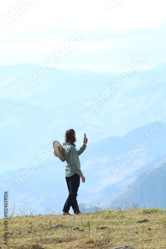 mulher fotografando montanhas na serra da mantiqueira em gonçalves, minas gerais 