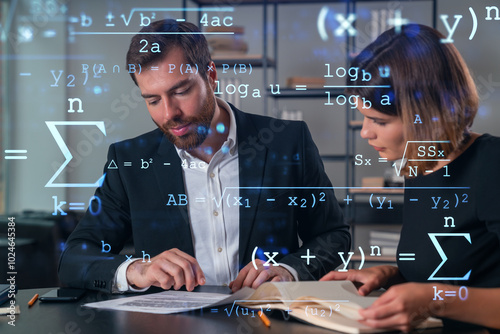 Professionals analyzing mathematical formulas in modern office setting. photo