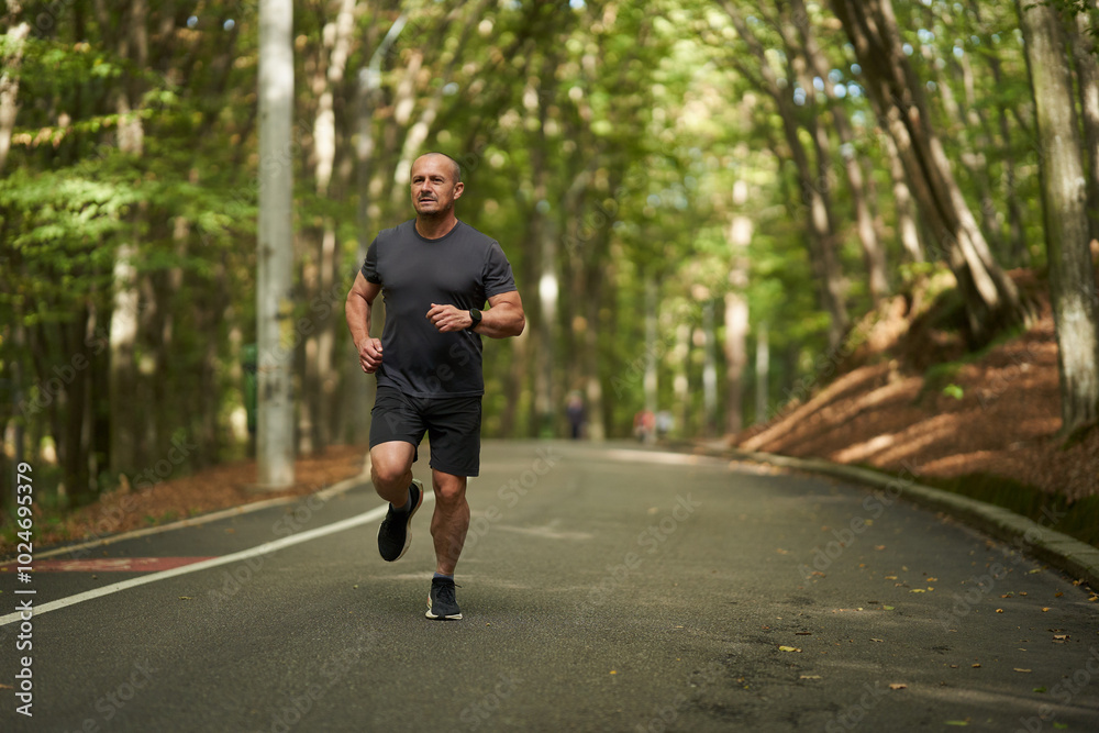 Athletic man running in park Athletic man running in park