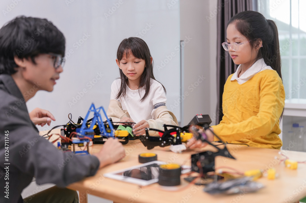 children working on circuit boards of small robot at technology and engineering workshop,elementary children learning STEM Education in school class, children working on circuit boards of small robot at technology and engineering workshop,elementary children learning STEM Education in school class,