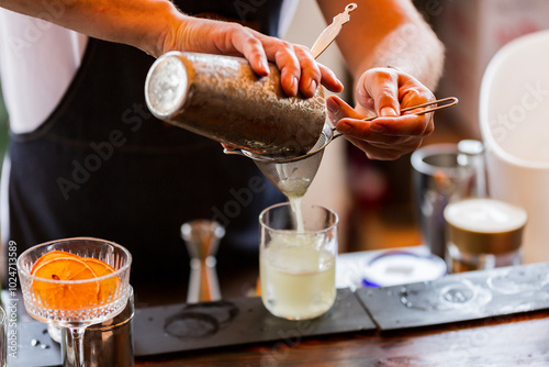 a bartender makes a cocktail. a bartender makes an alcoholic refreshing summer cocktail