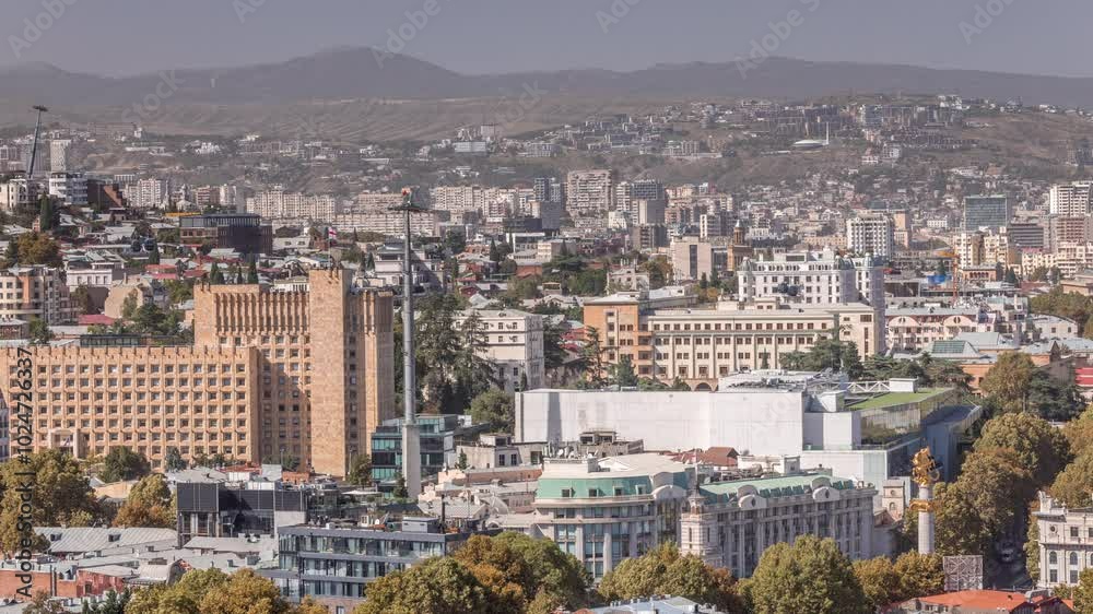 Aerial view of column on the freedom square in the center of the city timelapse. St. George monument of liberty in Tbilisi. Historic buildings rooftops from viewpoint. Georgia Aerial view of column on the freedom square in the center of the city timelapse. St. George monument of liberty in Tbilisi. Historic buildings rooftops from viewpoint. Georgia