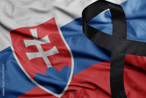Photography waving national flag of slovakia with black mourning ribbon
