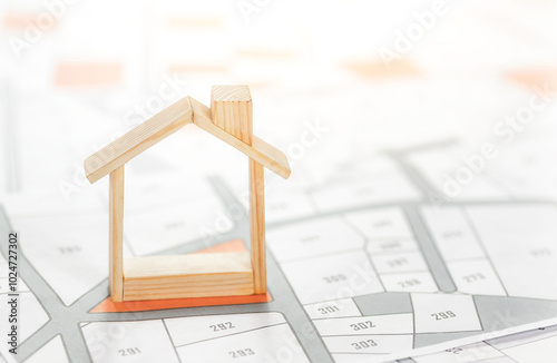 The house is placed on the land map. choose the land location building plot for house construction. real estate concept with vacant land for building construction for sale, rent, buy, investment.