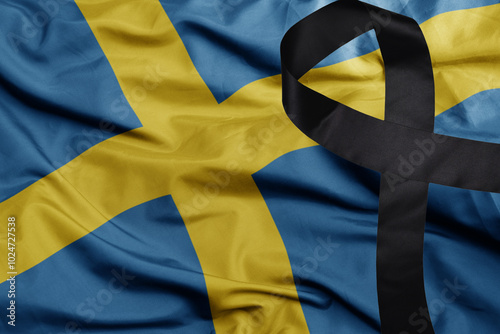 waving national flag of sweden with black mourning ribbon .tragedy concept