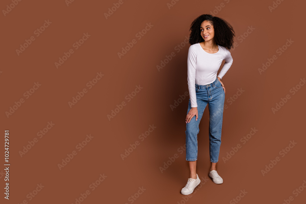 Full body portrait of nice young woman look empty space wear pullover isolated on brown color background Full body portrait of nice young woman look empty space wear pullover isolated on brown color background