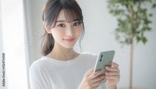 A closeup of a beautiful Asian Japanese woman using her smartphone