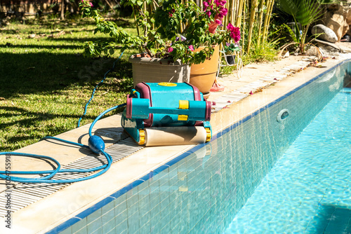 Wired automatic submersible vacuum cleaning robot that sweeps the floor and walls of the pool in the water.