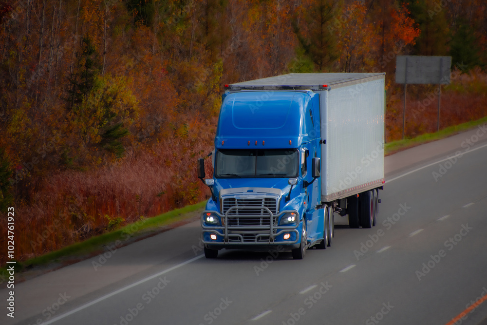 Heavy truck on a Canadian highway in the fall in Quebec Heavy truck on a Canadian highway in the fall in Quebec