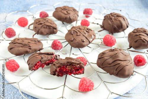 Raspberry jam coated with dark chocolate. Delicious dessert photo