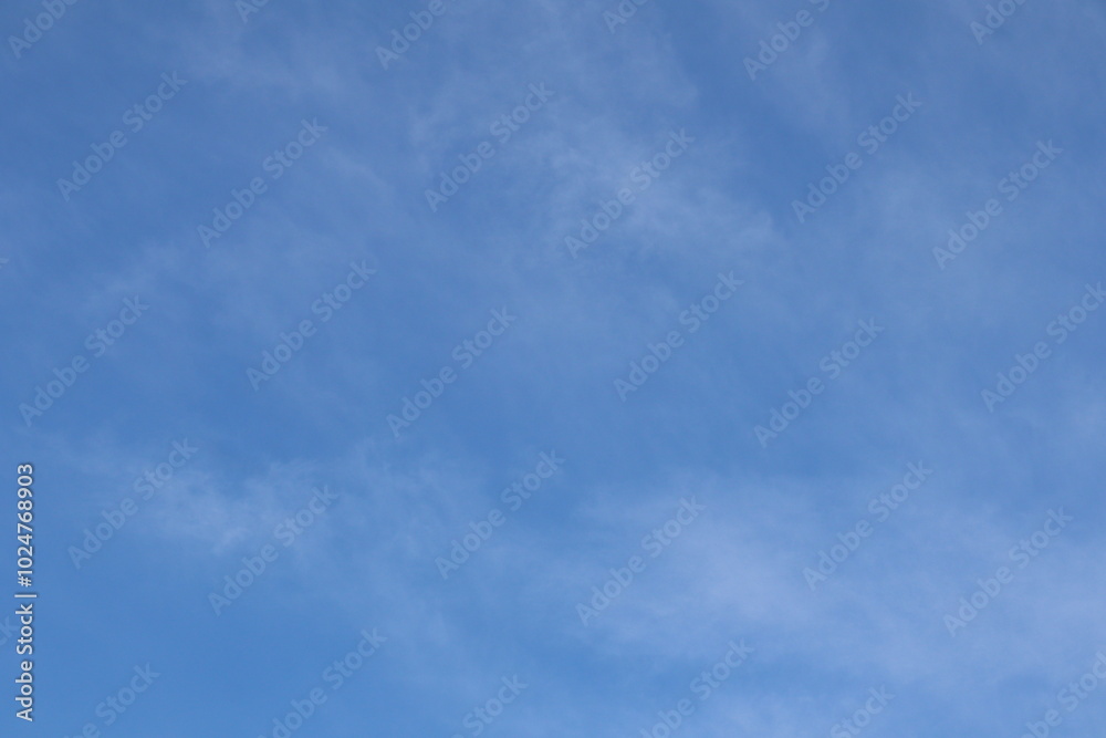 blue sky in late summer with light cirrus or cirrocumulus clouds as background blue sky in late summer with light cirrus or cirrocumulus clouds as background