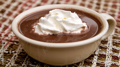 A cup of hot chocolate with whipped cream on top.