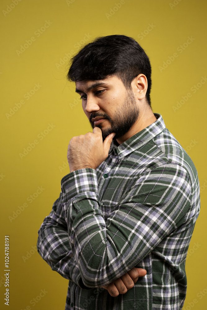 man with hand on chin, thoughtful and looking down man with hand on chin, thoughtful and looking down
