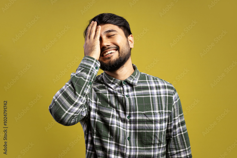 man with eyes closed, smiling, with his hand touching his face man with eyes closed, smiling, with his hand touching his face