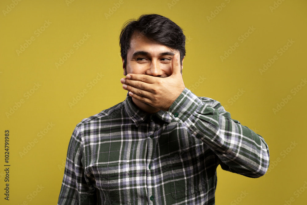Fototapeta premium man covering his smile with his left hand and looking to the side