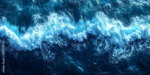 An aerial view of the ocean with waves crashing and creating a beautiful display of whitecaps. photo