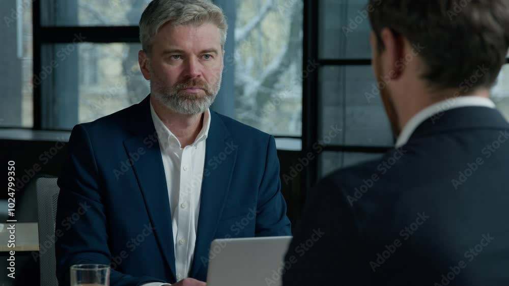 Serious Caucasian man consultant businessman consulting client business job interview in office employer hr manager communicate with male employee candidate men businessmen discuss project at meeting