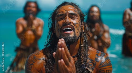 International Day of the World's Indigenous Peoples. A powerful image of a Maori man performing the traditional haka, with his tribal tattoos displayed and the ocean in background photo