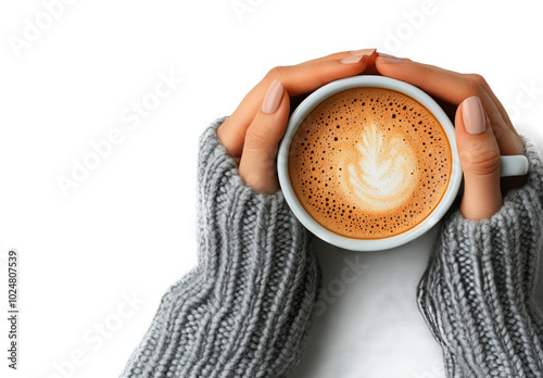Cozy hands holding a warm cup of coffee with latte art on a serene white back...