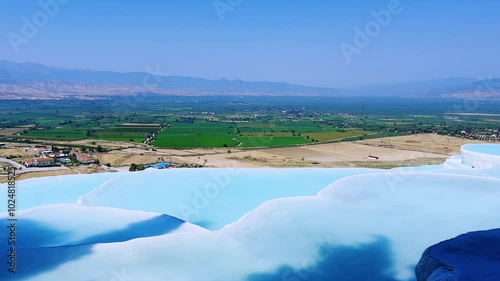 Travertines of Pamukkale - Denizli, Turkey. Natural pools and terraces made of travertine. Cotton castle. Hot blue springs, mineral waters forming limestone deposits of travertine. UNESCO. 4K