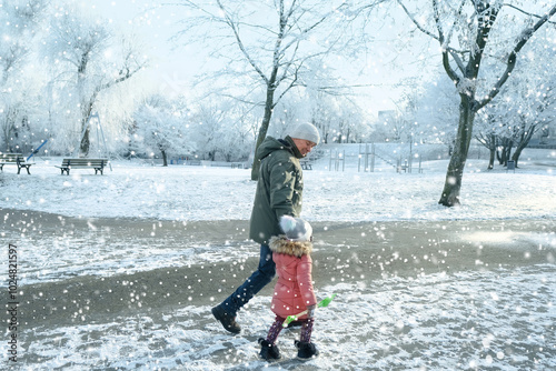 man and girl walk hand in hand down street to kindergarten, city park in winter, beautiful crystal frost on foliage and tree branches, frosty morning, weather concept