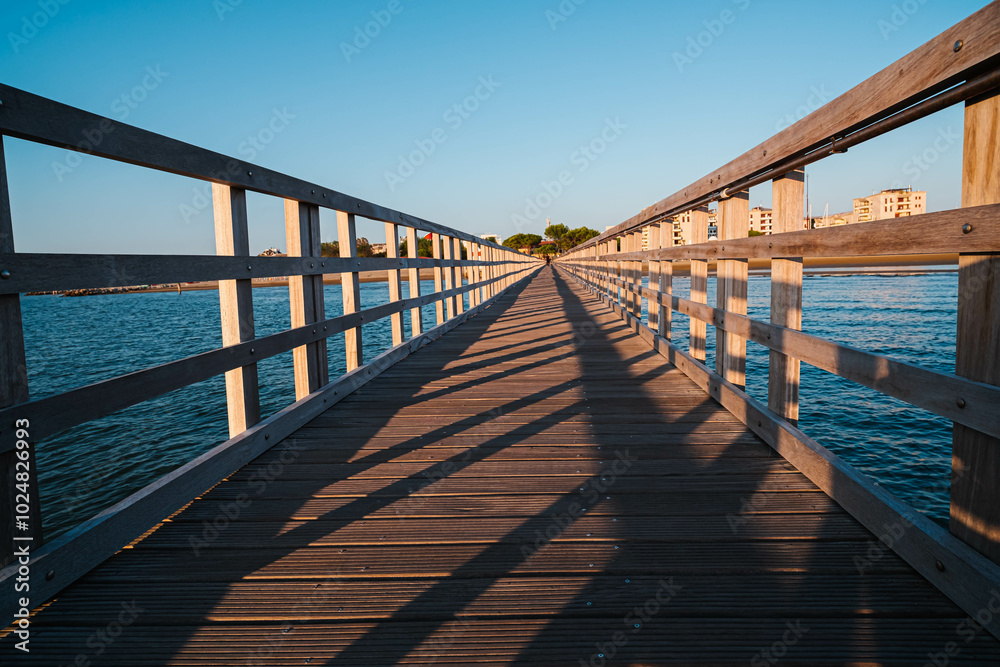 The planked passage to the coast on the seashore during the golden hour at dawn The planked passage to the coast on the seashore during the golden hour at dawn