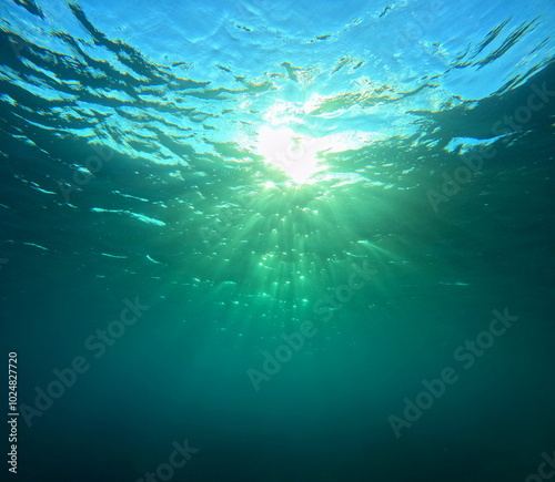 light diffraction and sun rays seen from undersea. underwater sunshine