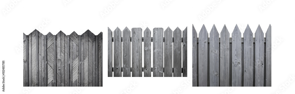 A weathered, gray wooden fence with pointed tops.